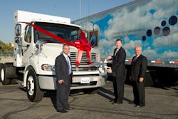From left to right: Steve Mignardi, director of national accounts, Daimler Trucks North America; Scott Perry, vice president, supply management, Ryder Fleet Management Solutions; and Robert Carrick, vocational sales manager natural gas, Freightliner Trucks, Daimler Trucks North America. Mr. Perry cuts the red ribbon from Ryder&rsquo;s new Freightliner M2 112 CNG truck, the 1,000th natural gas truck produced by Freightliner Trucks, during a ceremony at Angel Stadium in Anaheim, Calif. on Nov. 7.