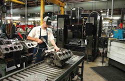 Operator installs torque plate on the block before setup in the Sunnen SV-410 machine or CK-21 immediately to the right in photo. Operator installs torque plate on the block before setup in the Sunnen SV-410 machine or CK-21 immediately to the right in photo.