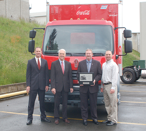 Kenworth Truck Company's first Kenworth K370 canover was officially presented to the Coca-Cola Refreshments fleet operation in Bellevue, Wash., during a special ceremony on May 24. From left are Preston Feight, Kenworth assistant general manager for sales and marketing; Gary Moore, Kenworth general manager and PACCAR vice president; Coca-Cola Refreshments' Bob Slack, vice president for the Pacific Northwest Marketings Unit; and Curt Kazen, Bellevue distribution manager.