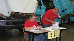Jacob Gaylor, Mid-America Technology Center post-secondary student, ponders an electrical problem alongside Clarence Preston, Cummins Southern Plains technician, in the 2012 Oklahoma SuperTech Competition. Gaylor won 1st place honors in the student category and also won the Fastener Work Station.