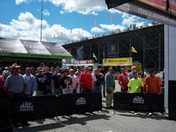 Attendees watch the crew prepare the engine for the Kalitta Motorsports at the Mac Tools U.S. Nationals a the Lucas Oil Raceway in Indianapolis, Ind.
