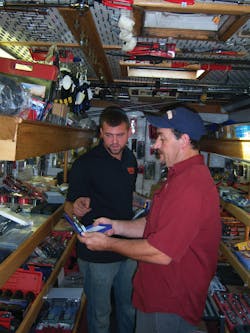A customer examines a new pair of pliers.