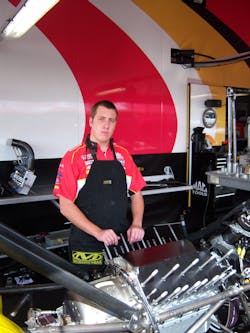 Jessie Snyder of the Kalitta Motorsports crew prepares to disassemble the engine. Jessie Snyder of the Kalitta Motorsports crew prepares to disassemble the engine.