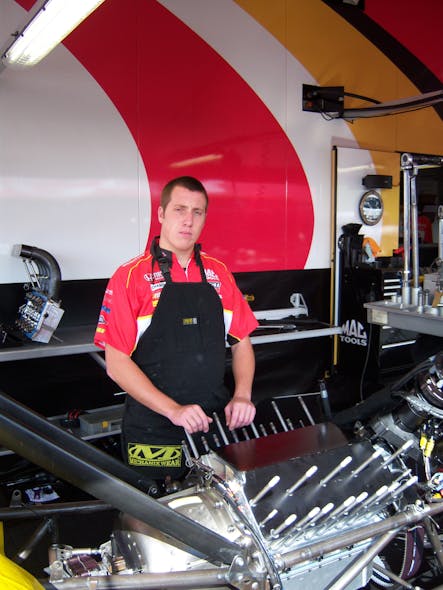 Jessie Snyder of the Kalitta Motorsports crew prepares to disassemble the engine.