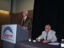 Ron Pyle, chairman of NASTF, at left, announces Skip Potter as the NASTF&apos;s first executive director during the ASRW show in New Orleans.