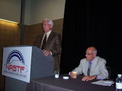 Ron Pyle, left, explains the role of the first NASTF executive director, Skip Potter, seated. Ron Pyle, left, explains the role of the first NASTF executive director, Skip Potter, seated.
