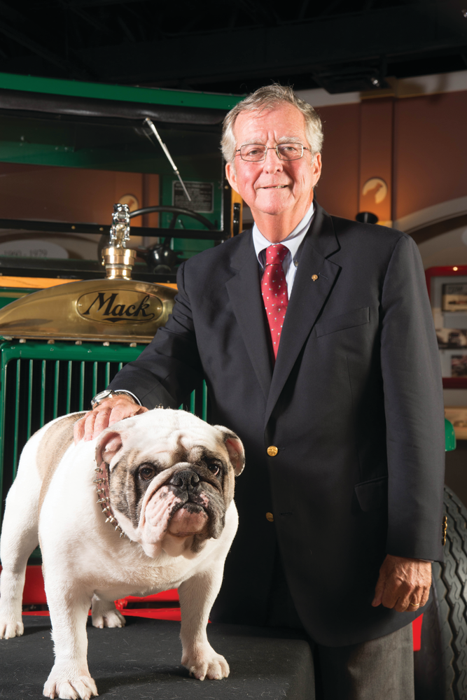 Kevin Flaherty, president, Mack Trucks North American Sales & Marketing, with Mack the Bulldog and the iconic Bulldog hood ornament in the background. A patent for the hood ornament was granted Oct. 11, 1932 &ndash; 80 years ago today.