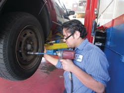 Figure 6: A mechanic using a torque stick to properly tighten lug nuts. Figure 6: A mechanic using a torque stick to properly tighten lug nuts.