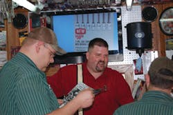 David Musil talking with customers. David Musil talking with customers.