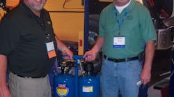 Karl Mathis, left, of Ritchie Engineering shows a Yellow Jacket mobile flushing tool to Roger Smith of Truck Air Service in Columbus, Ga.