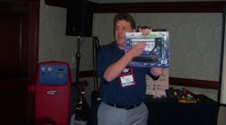 Dennis Eaton talks about Uview&apos;s Spotgun injection kit during a seminar at the Matco Tools national business conference.