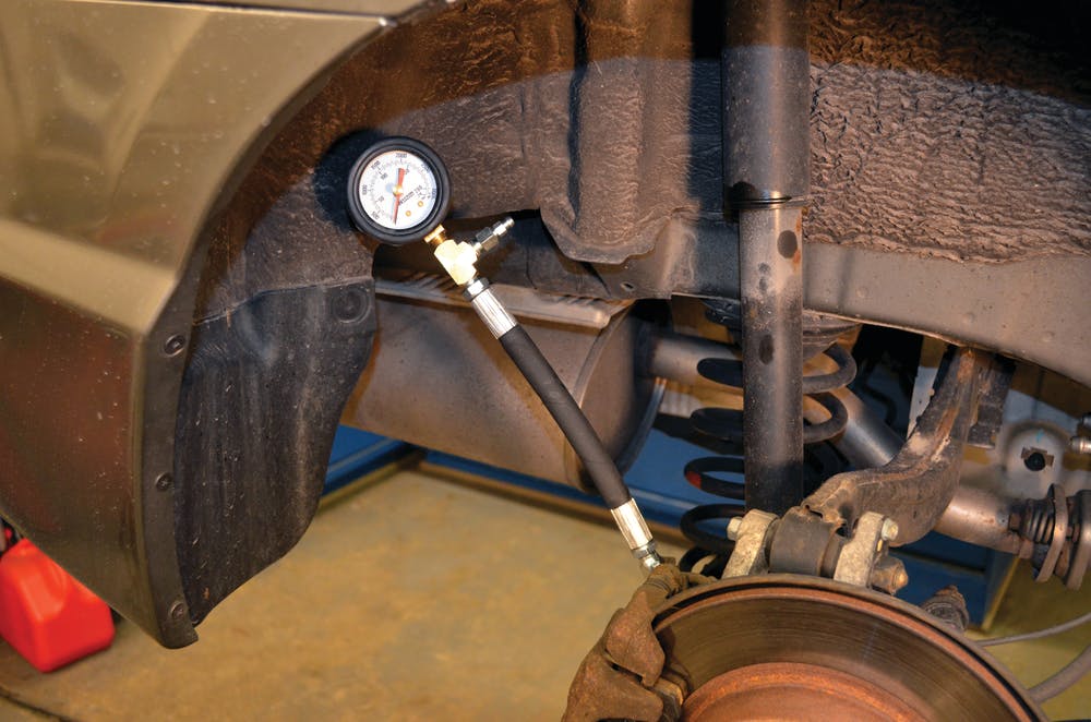 The Hickok Waekon gauge connects to the rear calipers of a 2006 Honda Civic. For information about this product, go to www.VehicleServiePros.com/10772314.