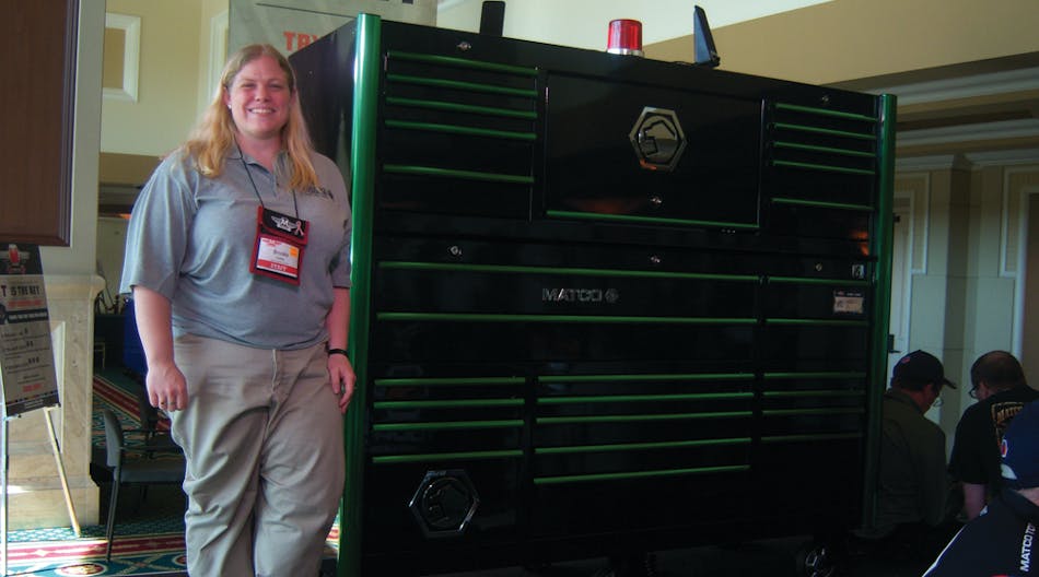 Brooke Colley of Matco Tools shows a green trim toolbox at the tool storage area.