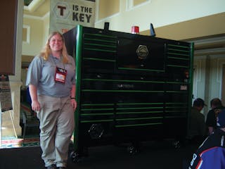 Brooke Colley of Matco Tools shows a green trim toolbox at the tool storage area.