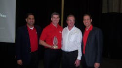 John Castelino, left, Don Guillard, third from left, and Brett Shaw, right, of Mac Tools honor Kirk Clore of Clore Automotive for the best new product of the year.