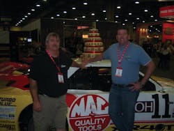 Bill Jaynes, left, and Chad Nelson of Titusville, Fla. enjoy race cars at the Mac Tools Tool Fair in Dallas, Texas. For more show photos, go to www.vehicleservicepros.com/10888366.