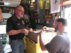 Seybold built up his business by maintaining excellent customer relations. Here, he is taking in a warranty. Seybold built up his business by maintaining excellent customer relations. Here, he is taking in a warranty.