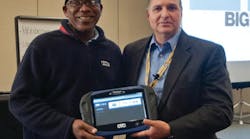 Norman Tennant being presented with an OTC Genisys Touch by TST president G &apos;Jerry&apos; Truglia.