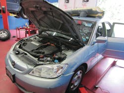 This 2005 Honda Civic Hybrid has an IMA light on. In order to access the HV battery, the rear seat has to be removed.