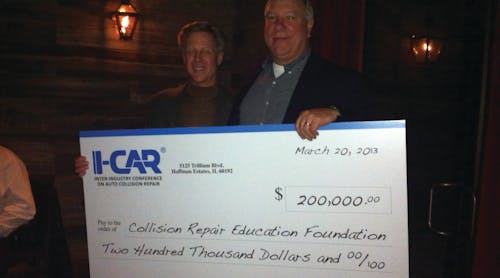 At left, John Van Alstyne, I-CAR CEO and president, presents the check to Clark Plucinski, Collision Repair Education Foundation executive director.