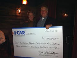At left, John Van Alstyne, I-CAR CEO and president, presents the check to Clark Plucinski, Collision Repair Education Foundation executive director.