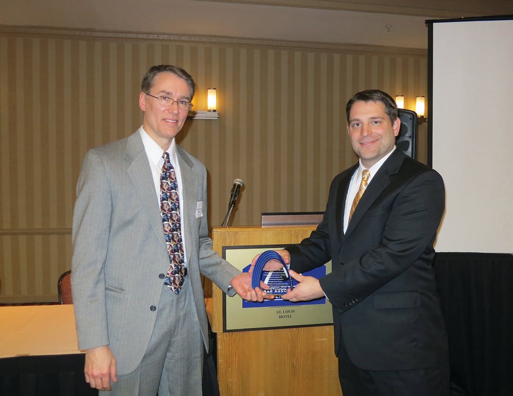 Hunter&rsquo;s Mike Douglas (left) accepts his Inventor of the Year Award from Paul Tietz, chair elect of BAMSL&apos;s patent, trademark and copyright) section.