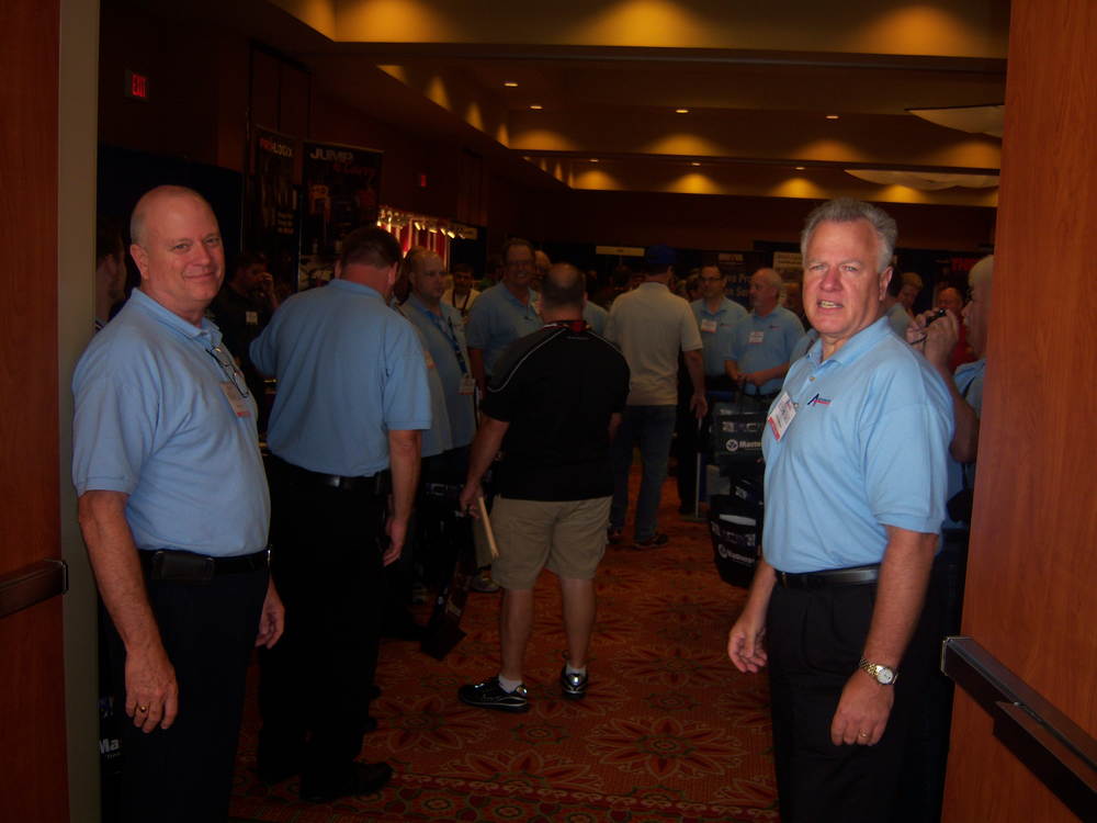 John Cross, left, and Pete Hofbauer, right, welcome attendees to the trade show during the grand opening.