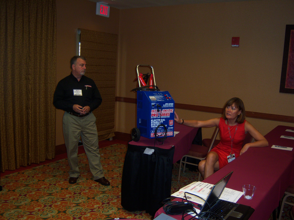 Joe Mocerino and Kim Cottle of Associated Equipment discuss the benefits of AGM batteries during the Ace Tool Co. dealer expo.