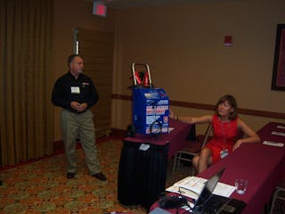 Joe Mocerino and Kim Cottle of Associated Equipment discuss the benefits of AGM batteries during the Ace Tool Co. dealer expo.