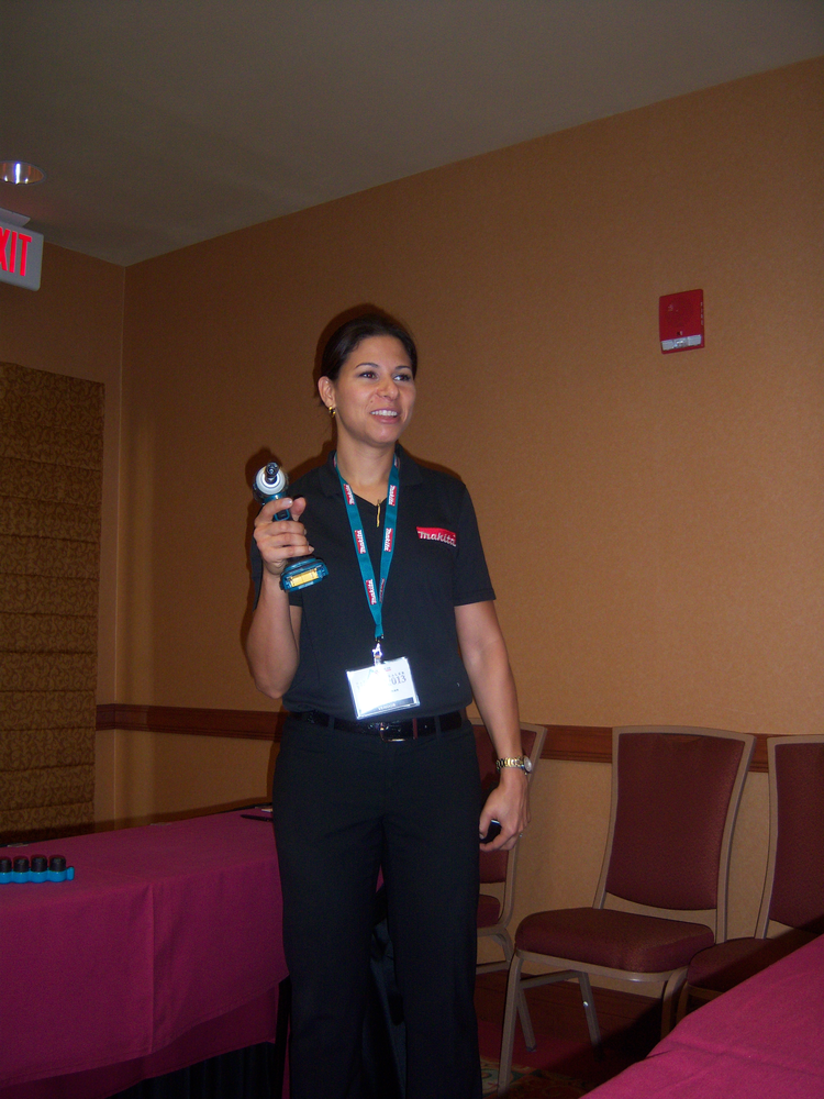 Tenille Redman demonstrates a Makita tool with a lithium ion battery.