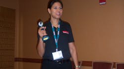Tenille Redman demonstrates a Makita tool with a lithium ion battery.