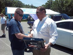 Marine presents Automotive Lift Institute (ALI) with U.S. flag that flew over Afghanistan base. Marine presents Automotive Lift Institute (ALI) with U.S. flag that flew over Afghanistan base.