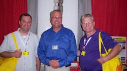 Patrick Wilson, left, and Joe Gyarmati III, right, of Mighty Distributing in Cincinnati, Ohio learn about Ken Tool tools from Rock Tyson.
