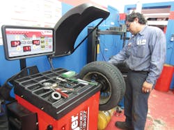 Mejia reported that set-up with the Ranger DST64T wheel balancer was a breeze. The user simply pulls out the arms to the left and right of the balancer and touch the rim snugly. They automatically input the tire height, width and rim size. In this picture, Mejia is placing the arm to the right of the balancer on the rim. After use, it snaps back into place.