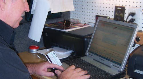 Bill Jaynes rings up a sale using a customer&apos;s credit card.