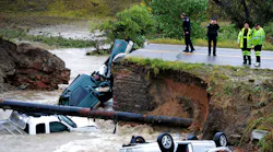 Officials investigate the scene of a road collapse at Highway 287 and Dillon at the Broomfield/Lafayette border, Colo., that sent three vehicles into the water after flash flooding on Thursday, Sept. 12, 2013. The National Weather Service has warned of an 'extremely dangerous and life-threatening situation' throughout the region. (AP Photo/Daily Camera, Cliff Grassmick)