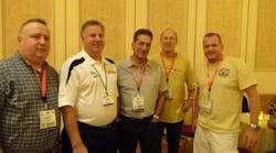 At left, Tony Quinn, Mike Procter, Steve Gill, Scott Buechler and John Duden of Autologue Compuer Systems enjoy AAPEX hospitality. The company supplies inventory management systems for automotive warehouse distributors and jobbers.
