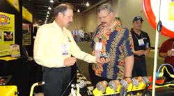 Bernie Thompson, left, of Automotive Test Solutions shows the Bullseye leak detector system, which can detect small leaks, at the 2013 AAPEX show.