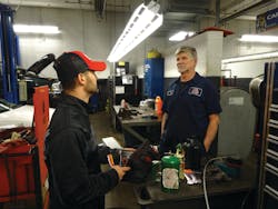 Manning delivers his monthly flyers to a customer. Manning delivers his monthly flyers to a customer.