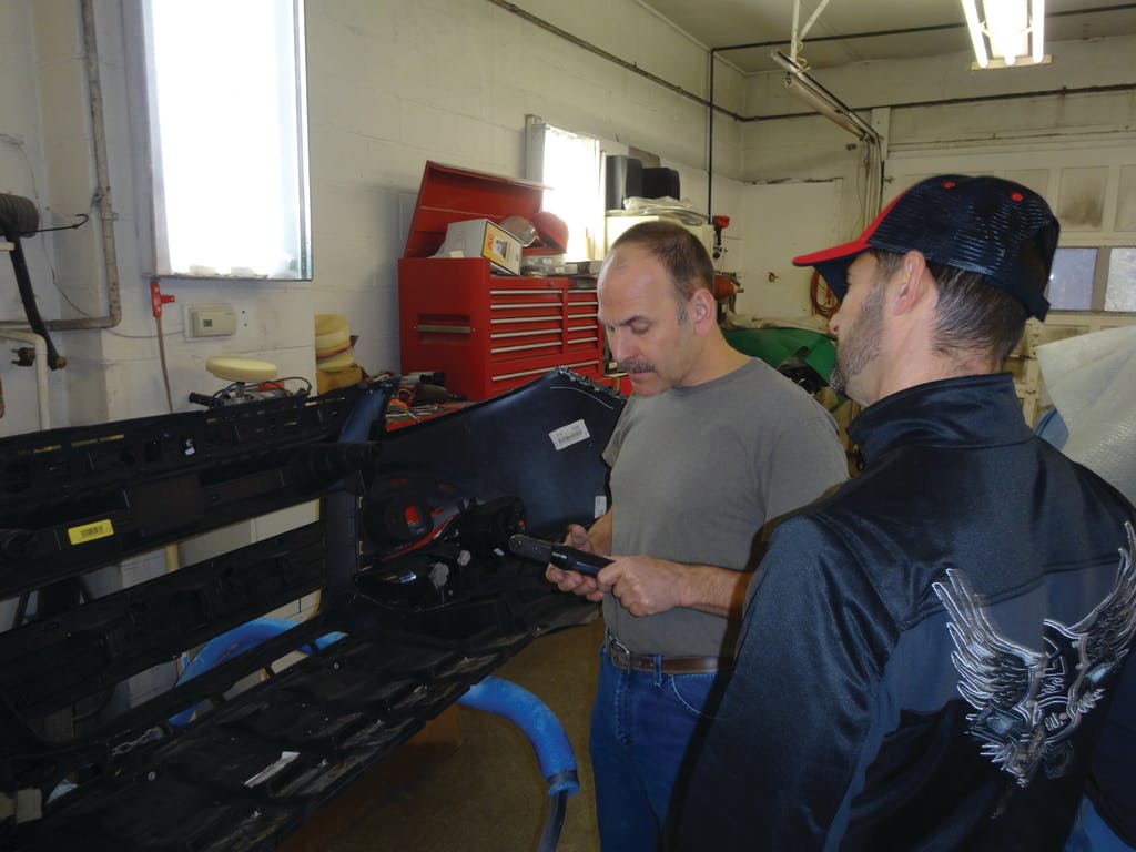 A customer looks at a 1/4&apos; air ratchet Manning brought into the shop.