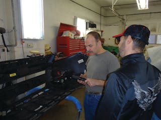 A customer looks at a 1/4&apos; air ratchet Manning brought into the shop.