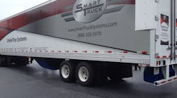 This photo shows three of the four aerodynamic device components that fleets can equip on their trailers. The undertray (blue) at the bottom middle of the trailer, the rear diffuser (blue) at the bottom back of the trailer, and the AeroEdge side fairings (white) at the top back part of the trailer.