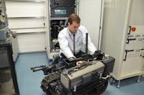 A TARDEC engineer integrates a hydrogen fuel cell onto a small tracked robot in the Fuel Cell lab at the GSPEL.