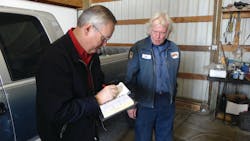 Shipler fills out a receipt for a customer. Shipler fills out a receipt for a customer.