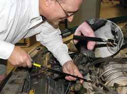 Phil Fournier connects the probe to a wire by piercing the insulation with needles in the end of the brass shaft of the probe. Phil Fournier connects the probe to a wire by piercing the insulation with needles in the end of the brass shaft of the probe.