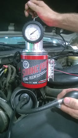 The tech pumps the Redline Easy Intake to seal off the vehicles intake duct and to introduce smoke into the intake system. For more information, go to VehicleservicePros.com/376405 The tech pumps the Redline Easy Intake to seal off the vehicles intake duct and to introduce smoke into the intake system. For more information, go to VehicleservicePros.com/376405