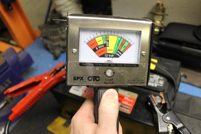 A load tester shows load being applied. Here, the dial indicates the battery is in good, based on the reading of the dial in the green.