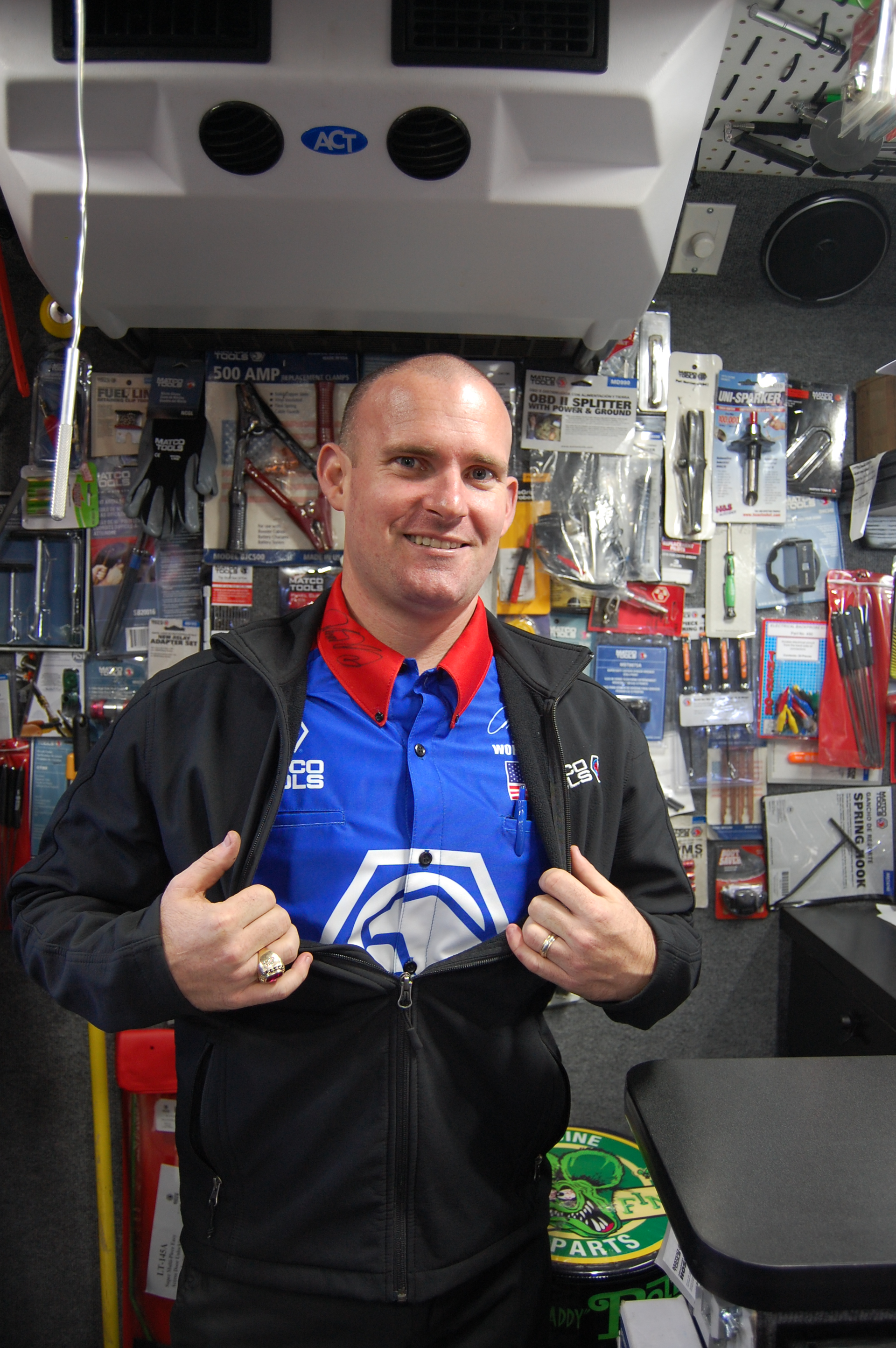 Wineinger proudly displays his racing shirt, signed by NHRA drag racer Antron Brown.