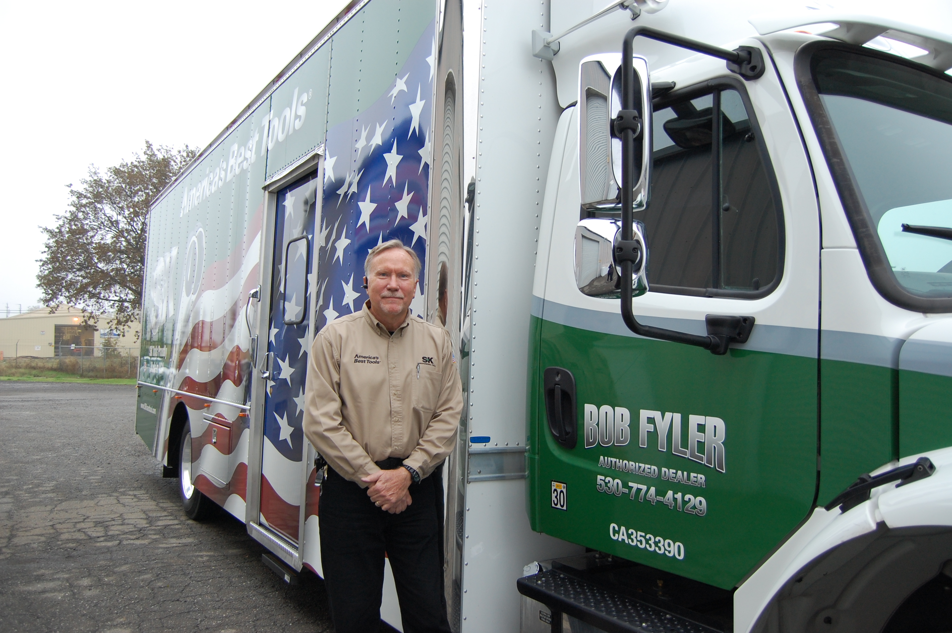 Independent distributor Bob Fyler stands next to his America's Best Tools-wrapped truck.