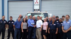 Todd Bloom (center left), MFTA&apos;s President &amp; CEO, presents the Mitsubishi Fuso North American Dealer of the Year Award to Frank Messina, dealer principal, as he is joined by other employees of Messina Truck Center, Tampa, Fla.